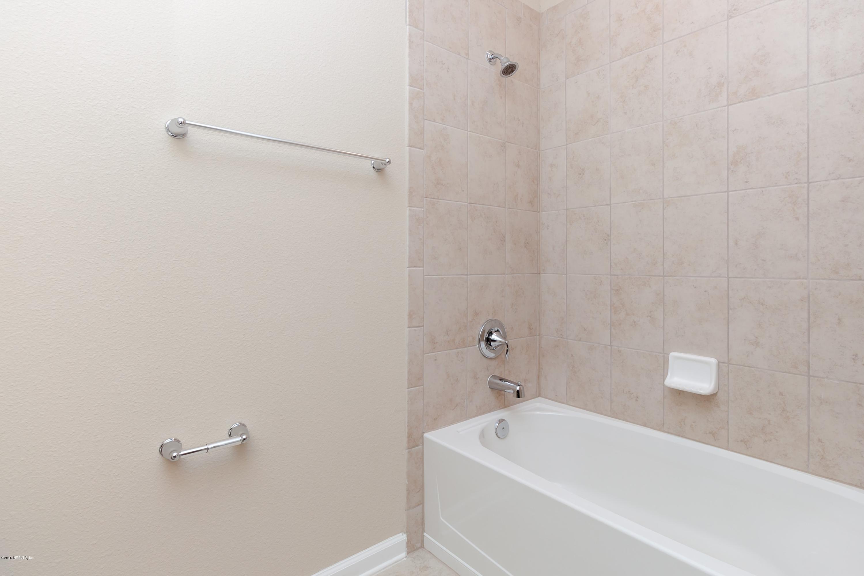 15714 Tisons Bluff Road Jacksonville, FL 32218 - Photo 36 of 44 a bathroom with a tub and a shower