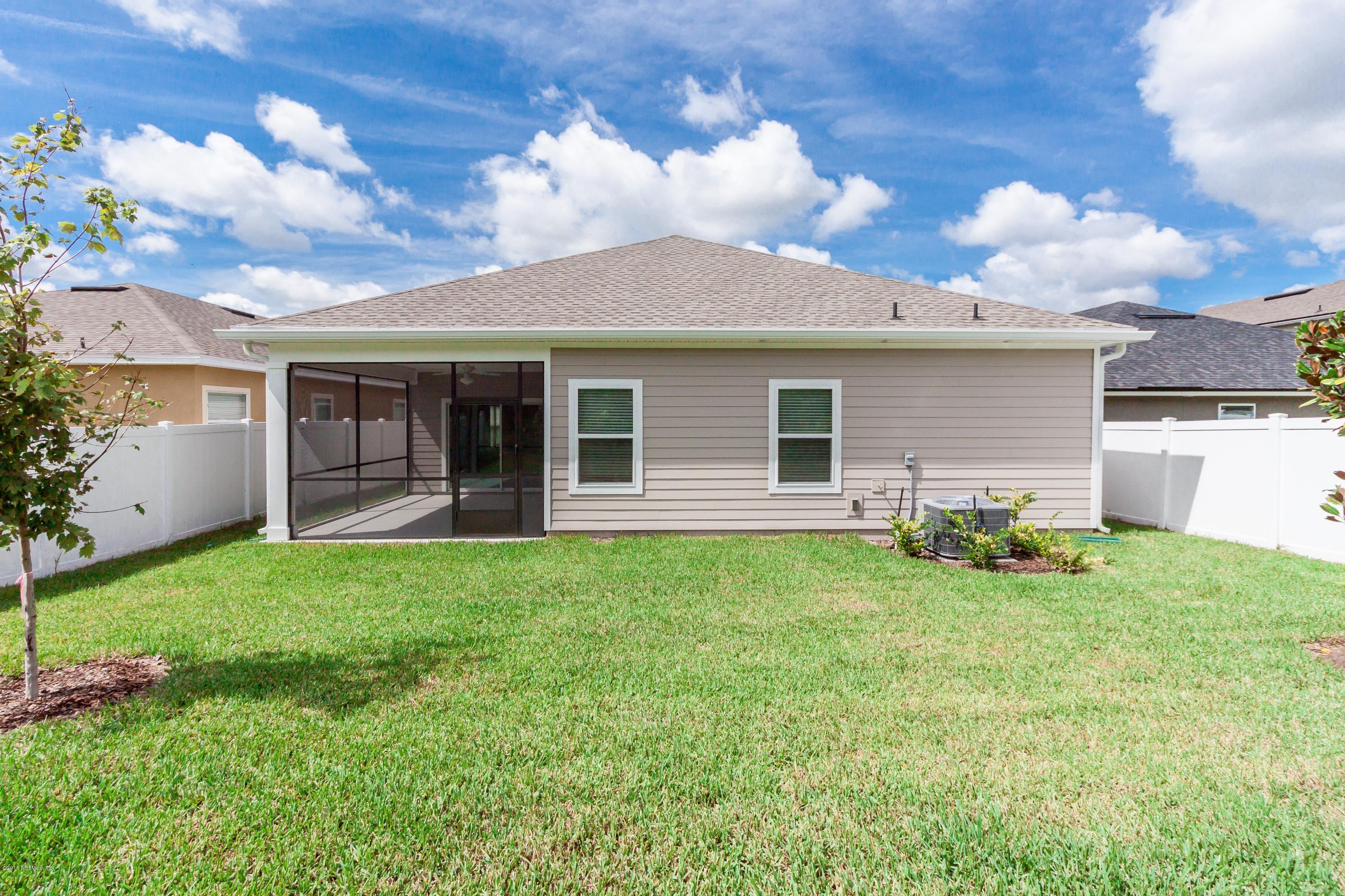 15714 Tisons Bluff Road Jacksonville, FL 32218 - Photo 43 of 44 a backyard of a house with table and chairs