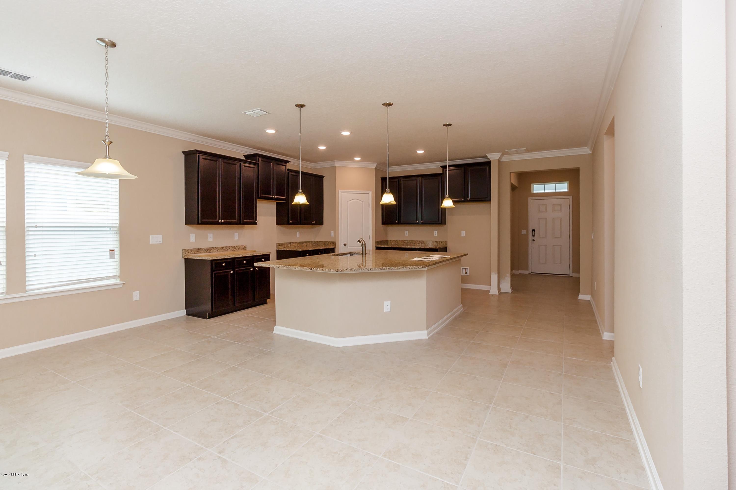 15714 Tisons Bluff Road Jacksonville, FL 32218 - Photo 9 of 44 a large kitchen with a large counter top stainless steel appliances and cabinets