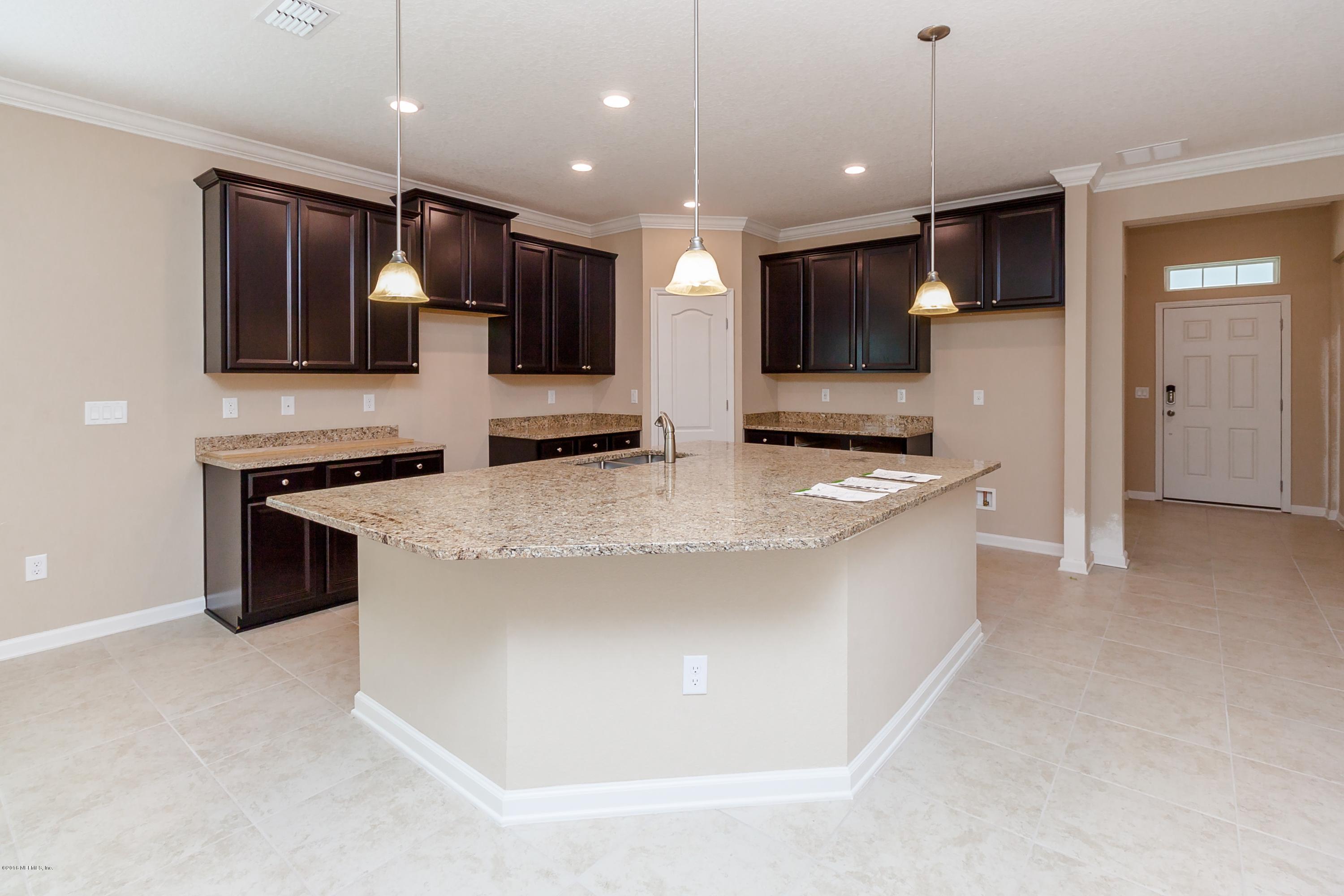 15714 Tisons Bluff Road Jacksonville, FL 32218 - Photo 10 of 44 a large kitchen with kitchen island granite countertop stainless steel appliances and a sink