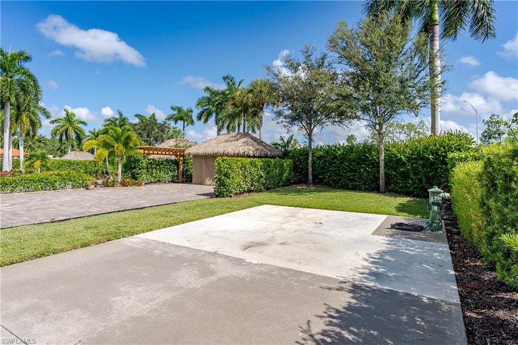 13611 Snook Circle Naples, FL 34114 - Photo 13 of 47 a view of a yard with plants and palm trees