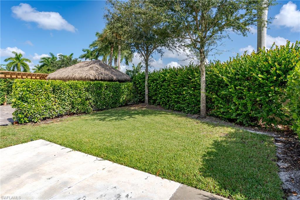 13611 Snook Circle Naples, FL 34114 - Photo 21 of 47 a view of a backyard with a garden