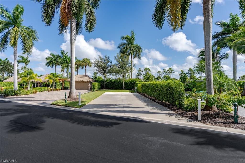13611 Snook Circle Naples, FL 34114 - Photo 3 of 47 a view of street with a fountain plants and palm trees