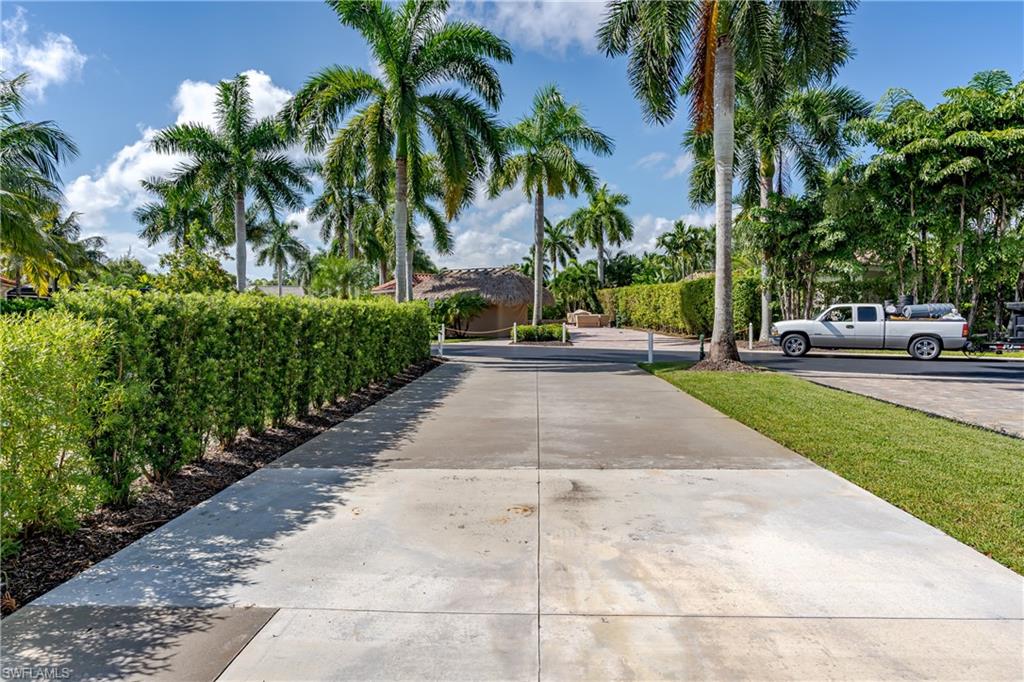 13611 Snook Circle Naples, FL 34114 - Photo 31 of 47 a view of a park with a bench and trees