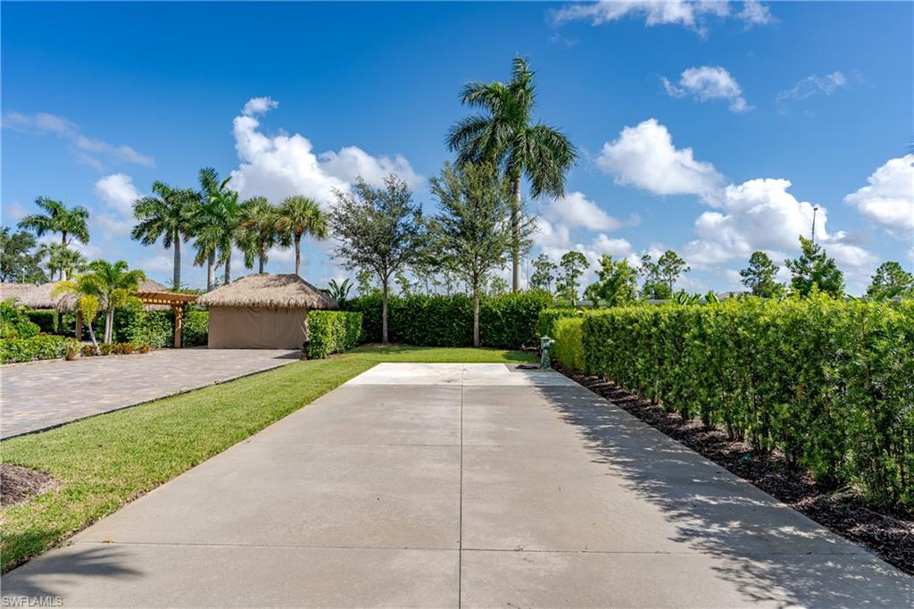 13611 Snook Circle Naples, FL 34114 - Photo 6 of 47 a view of a garden with a building in the background