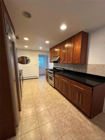 a kitchen with stainless steel appliances granite countertop a refrigerator and a sink