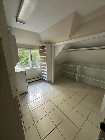 a view of a livingroom with furniture and a window