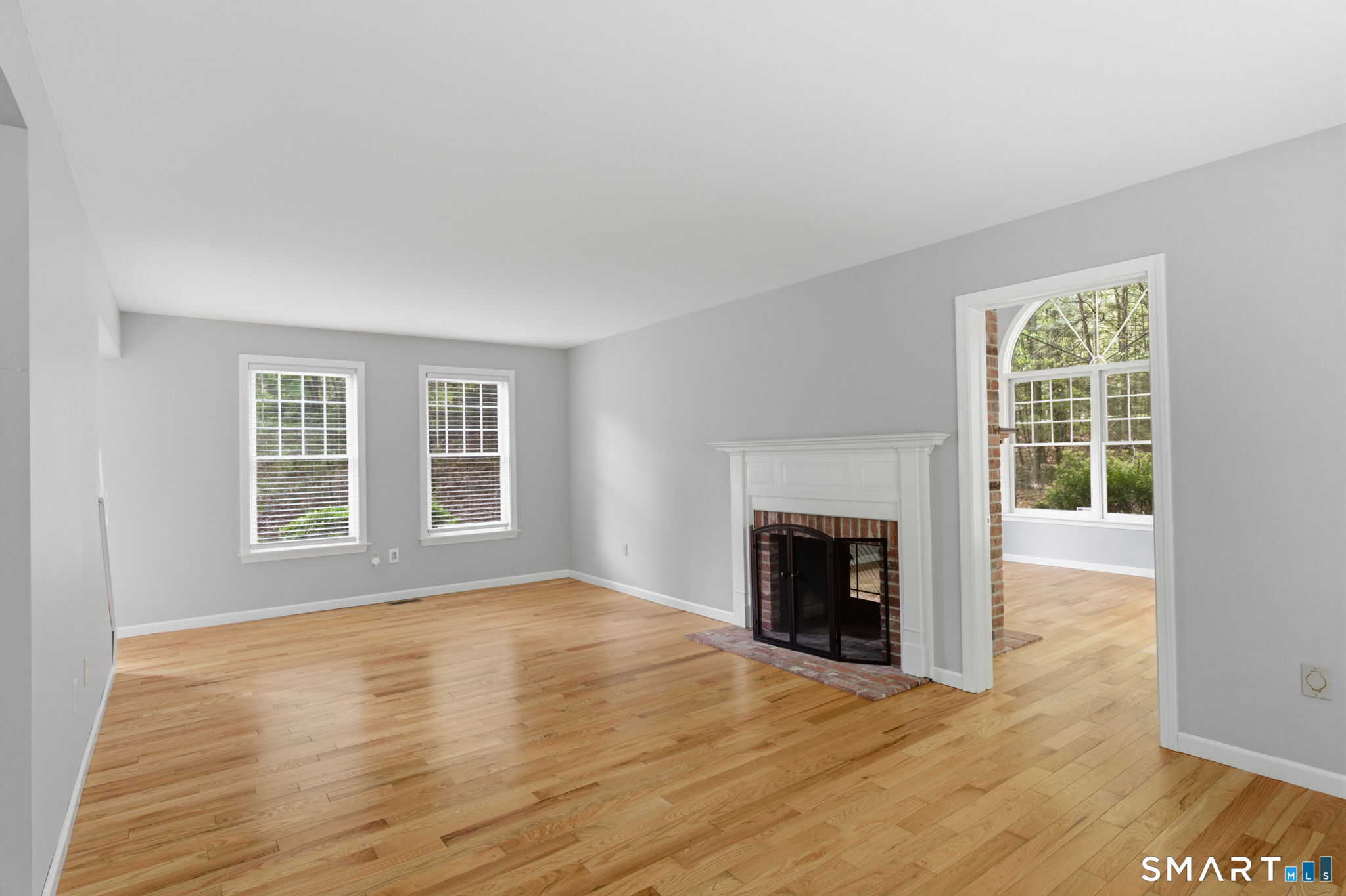 21 Greenwood Road North Granby, CT 06060 - Photo 5 of 40 a view of an empty room with wooden floor fireplace and a window
