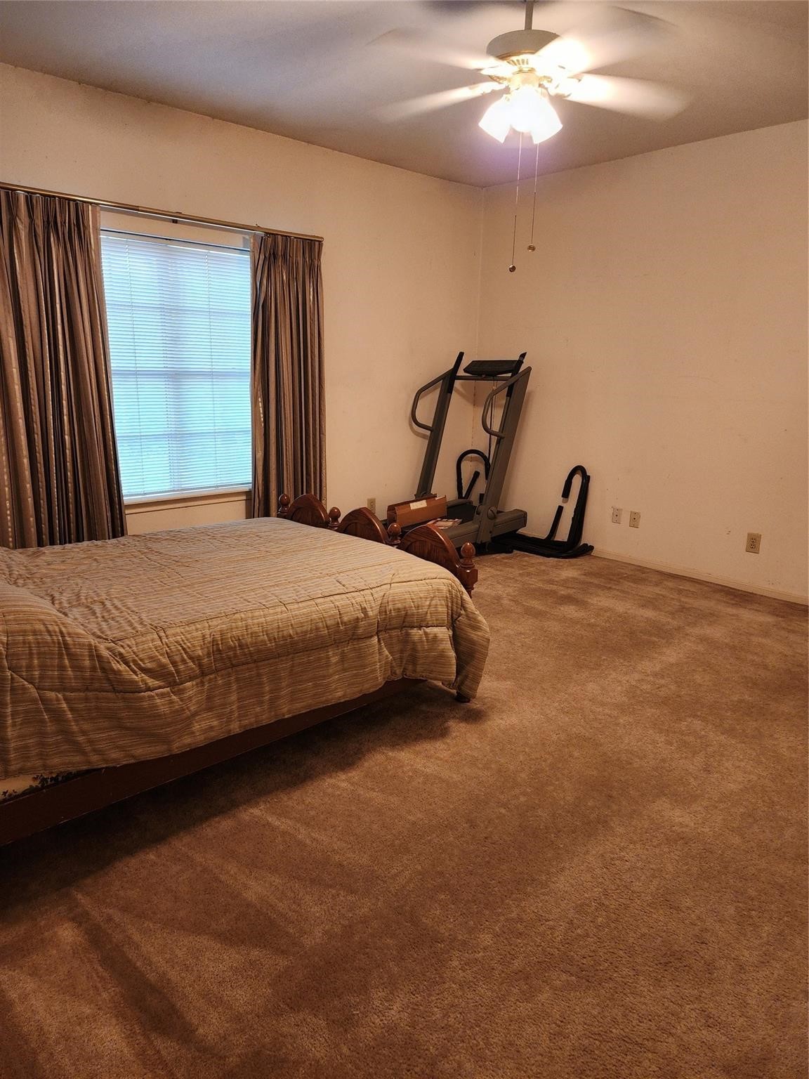 7399 Regency Square Court, Unit 7399 Houston, TX 77036 - Photo 17 of 27 a bedroom with a bed and a chandelier