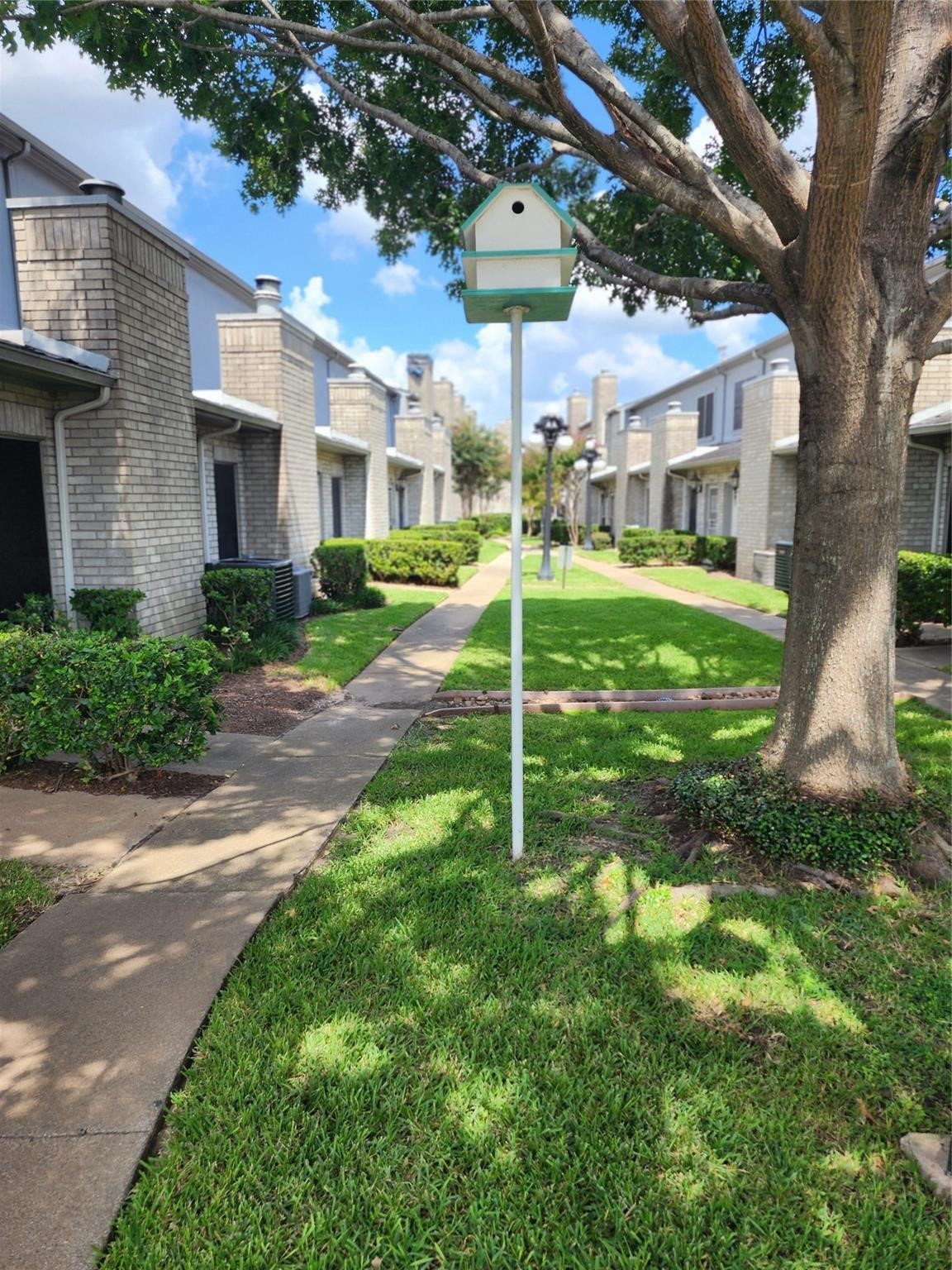 7399 Regency Square Court, Unit 7399 Houston, TX 77036 - Photo 25 of 27 a view of a house with a yard