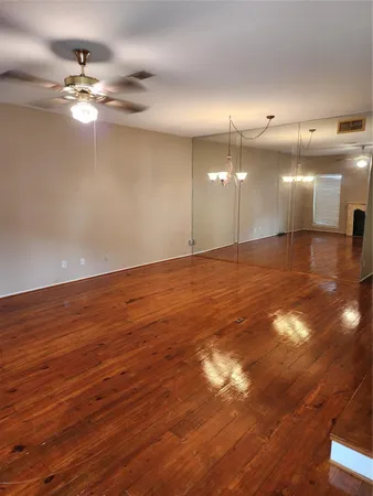 a view of a room with ceiling fan and window