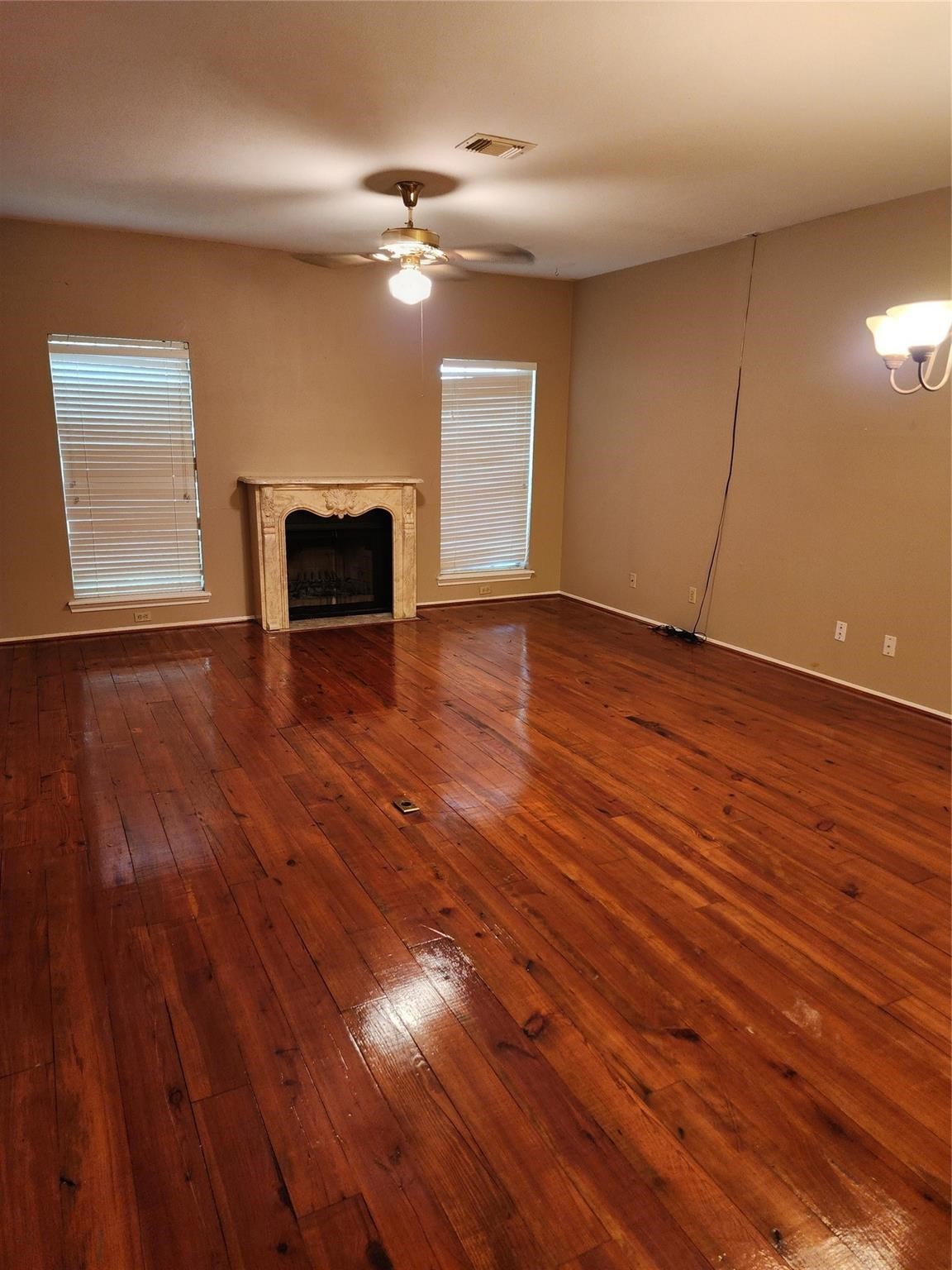 7399 Regency Square Court, Unit 7399 Houston, TX 77036 - Photo 5 of 27 a view of empty room with wooden floor and fan