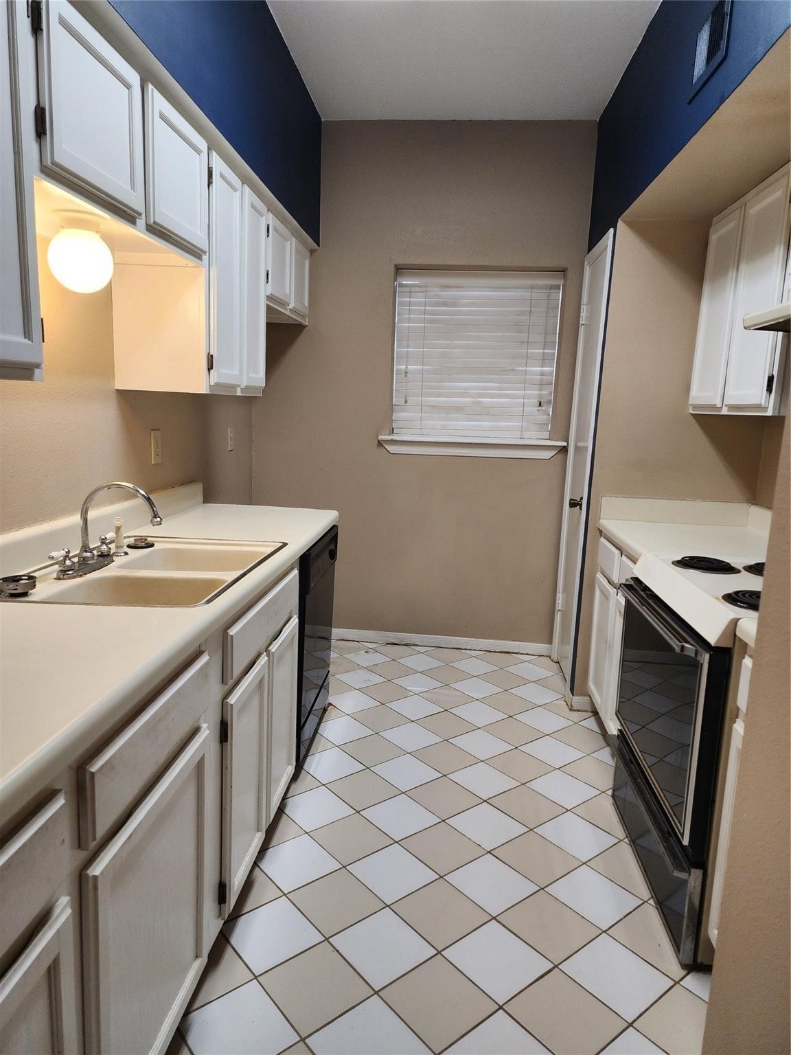 7399 Regency Square Court, Unit 7399 Houston, TX 77036 - Photo 6 of 27 a kitchen with stainless steel appliances a sink stove and microwave