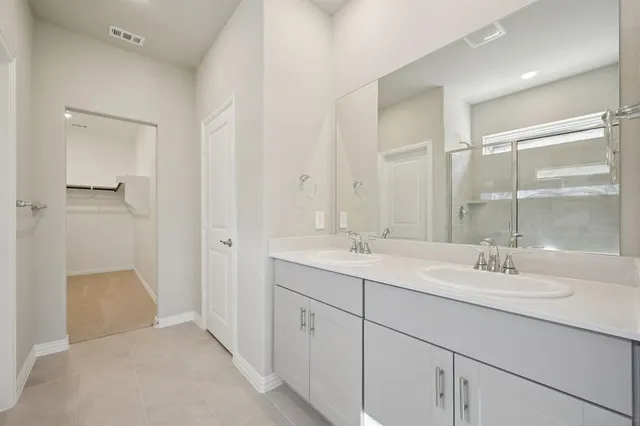 a bathroom with a double vanity sink mirror and double