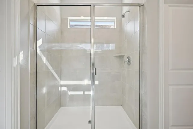 a bathroom with a glass shower door