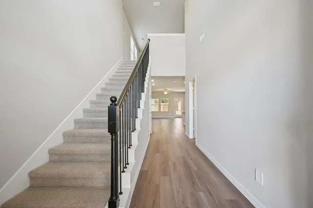 a view of a hallway with wooden floor and entryway