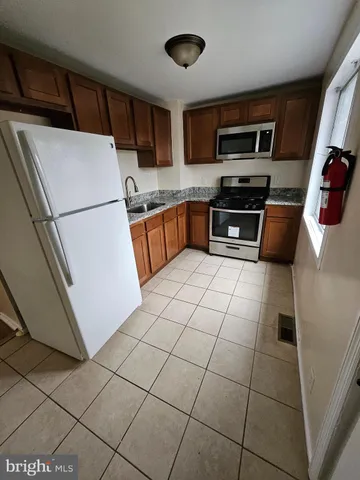 a kitchen with a sink a microwave and refrigerator