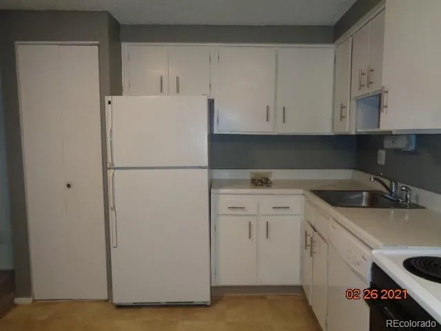 a white refrigerator freezer sitting inside of a kitchen