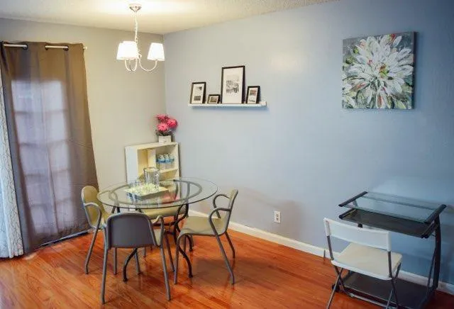 a view of a dining room with furniture and wooden floor
