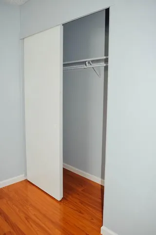 a view of a room with wooden floor