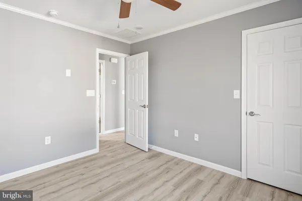 a view of an empty room with wooden floor