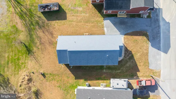 an aerial view of a house with a yard