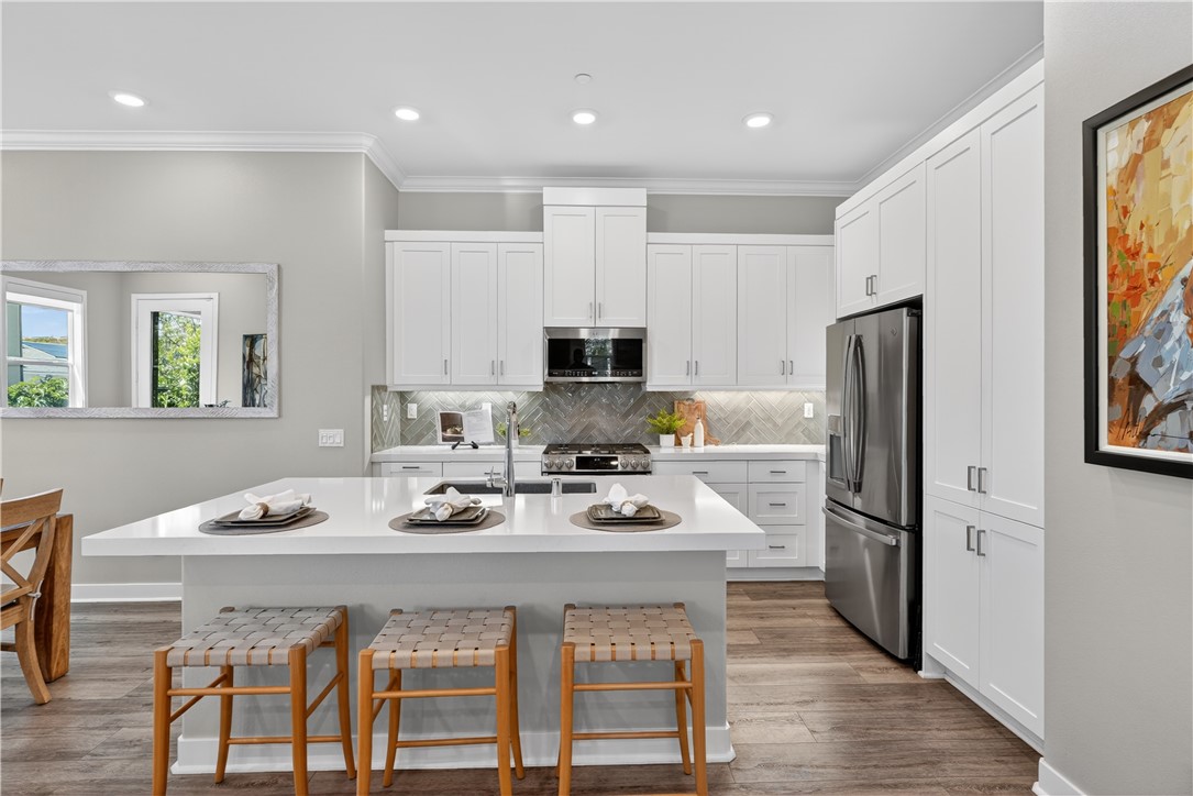 752 Sunrise Road Rancho Mission Viejo, CA 92694 - Photo 8 of 73 a kitchen with a dining table and chairs