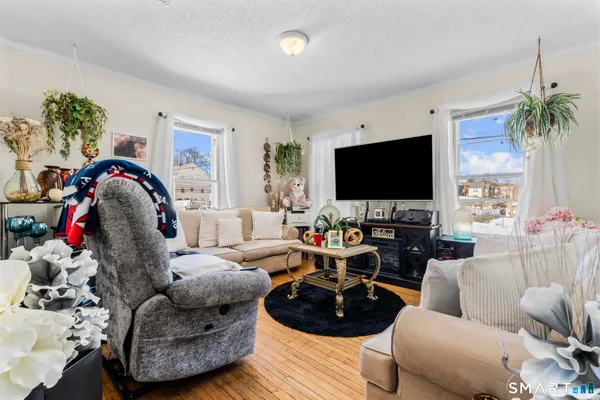 a view of a dining room with furniture and a kitchen