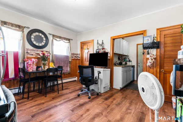 a view of a workspace with furniture and a flat screen tv