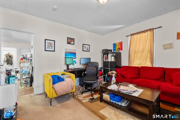 a living room with furniture cabinets and a window