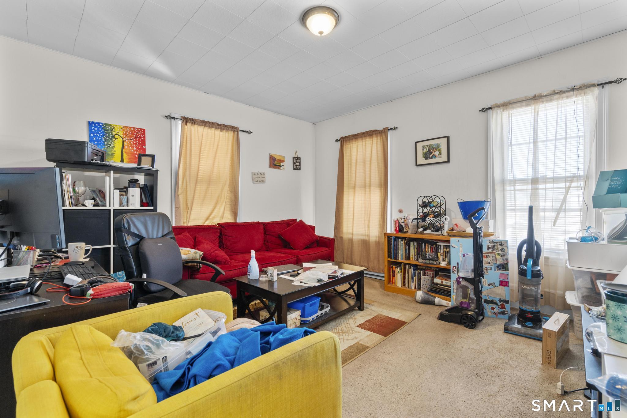 17 Austin Street New Britain, CT 06051 - Photo 27 of 40 a living room with furniture cabinets and a window