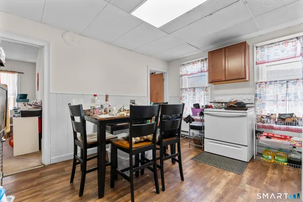a view of a dining room with furniture and wooden floor