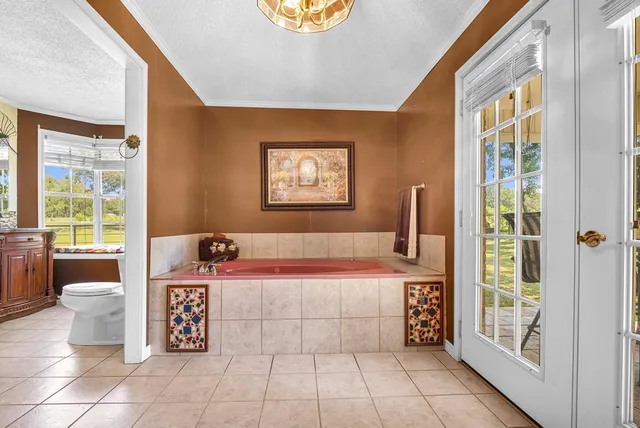 a spacious bathroom with a bathtub and next to a window