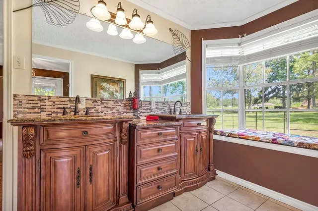 a kitchen with a large window and cabinets