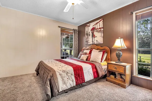 a bedroom with a bed and a chandelier