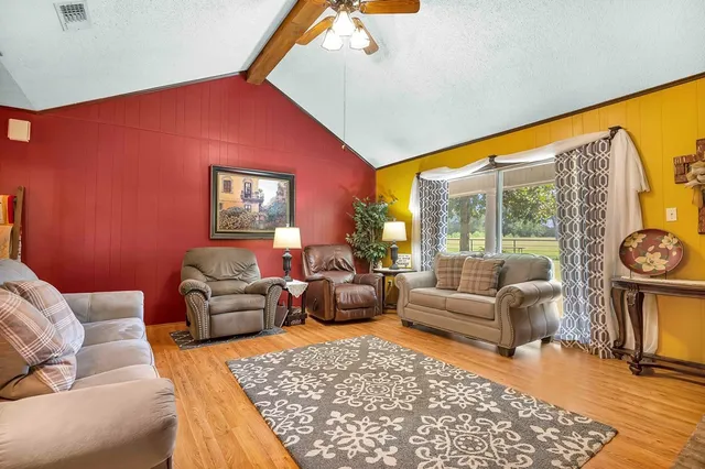 a living room with furniture and a floor to ceiling window