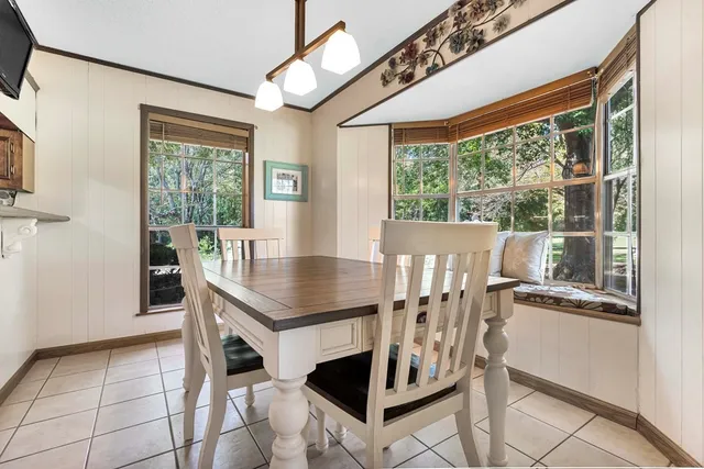 a view of a dining room with furniture window and outside view