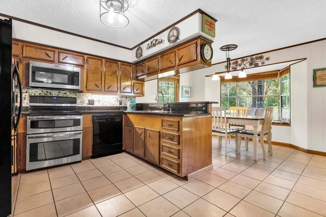 a kitchen with stainless steel appliances granite countertop a stove and a sink