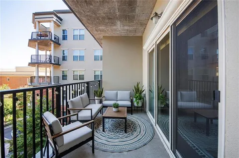 a living room with furniture and a floor to ceiling window
