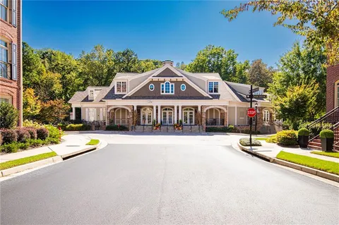 a front view of a house with swimming pool and porch