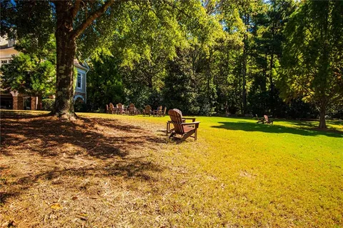 a house view with swimming pool in front of the house