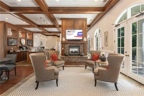 a living room with furniture a fireplace and windows