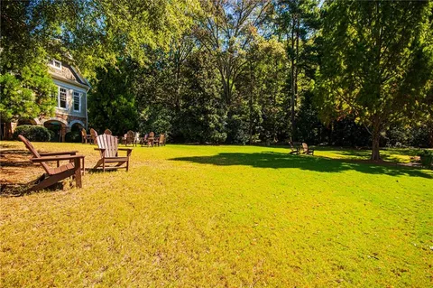 a view of a swimming pool with an outdoor seating and a yard