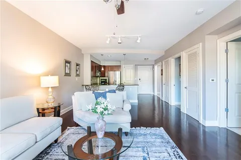 a dining room with furniture a rug and wooden floor