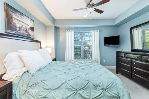 a bedroom with a bed and a flat screen tv