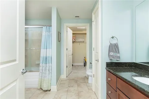 a view of a bathroom with a granite countertop sink and a mirror