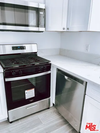 a stove top oven sitting inside of a kitchen