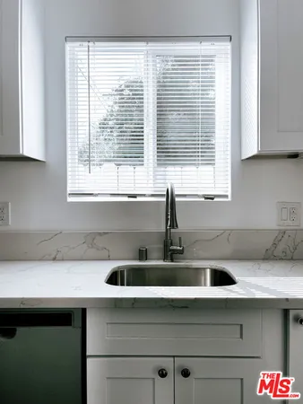 a kitchen with a sink and a window