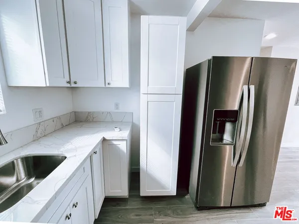 a kitchen with stainless steel appliances a refrigerator a sink and a stove