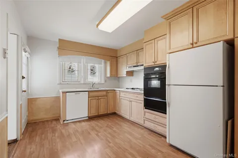a kitchen with granite countertop appliances a sink and a refrigerator